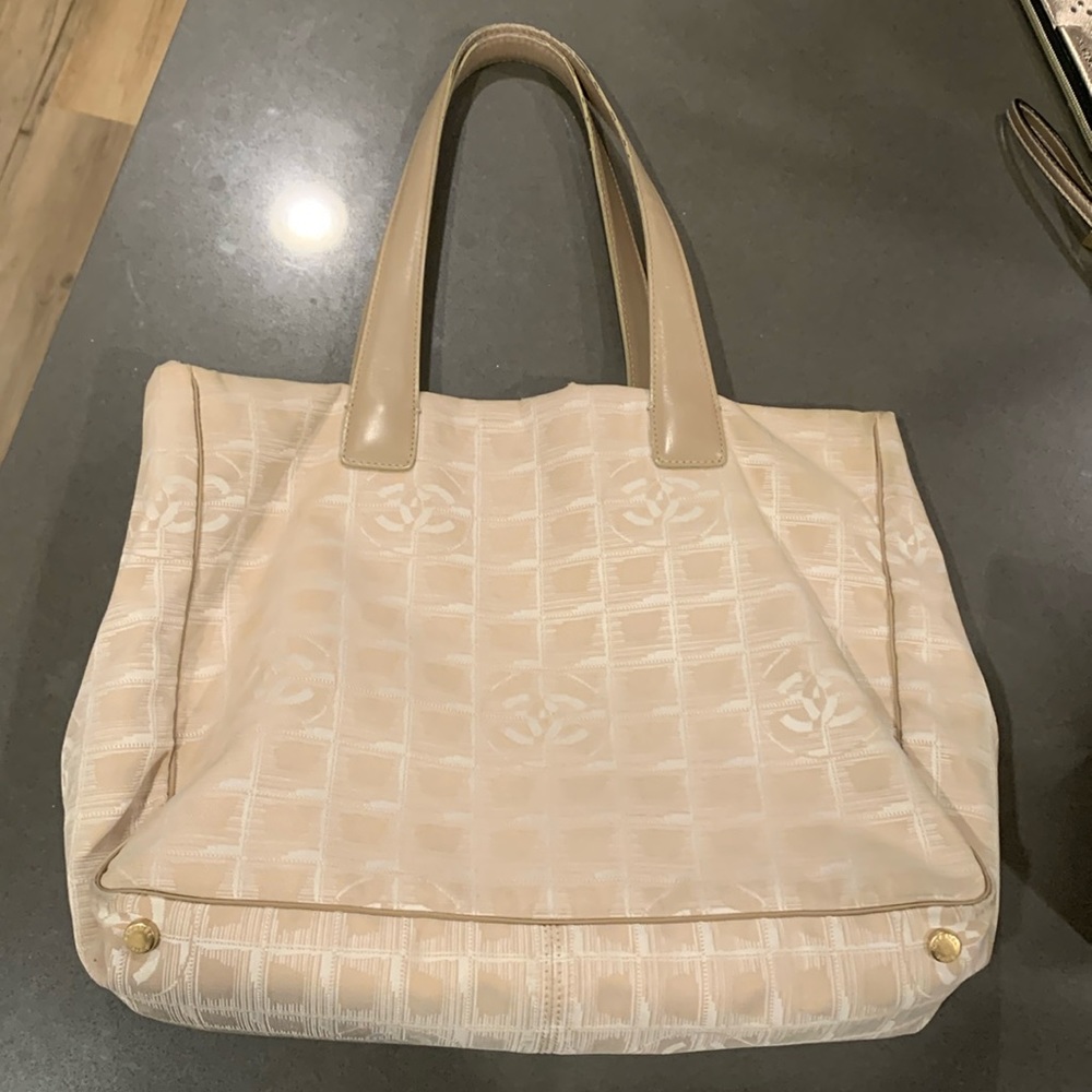 Authentic Chanel beige travel line canvas and leather tote. Date code is 8358878